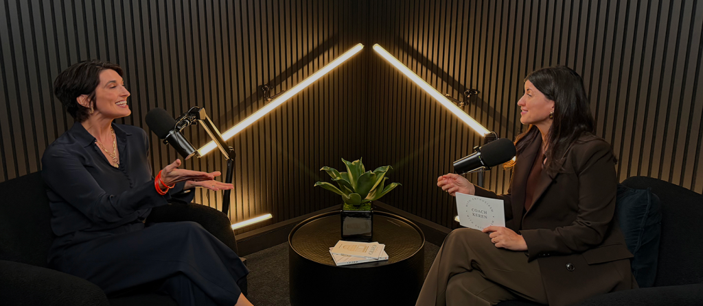 Carrie Fabris and a guest sitting on chairs and discussing a topic for the podcast