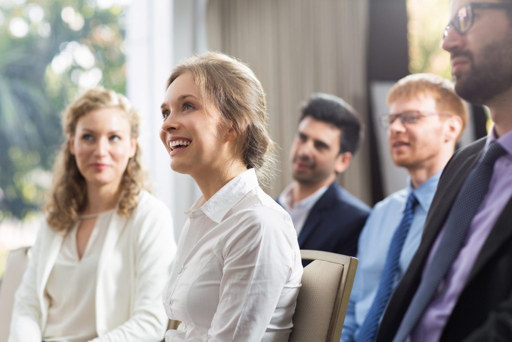 Business professionals sitting and attentively listening during a seminar.