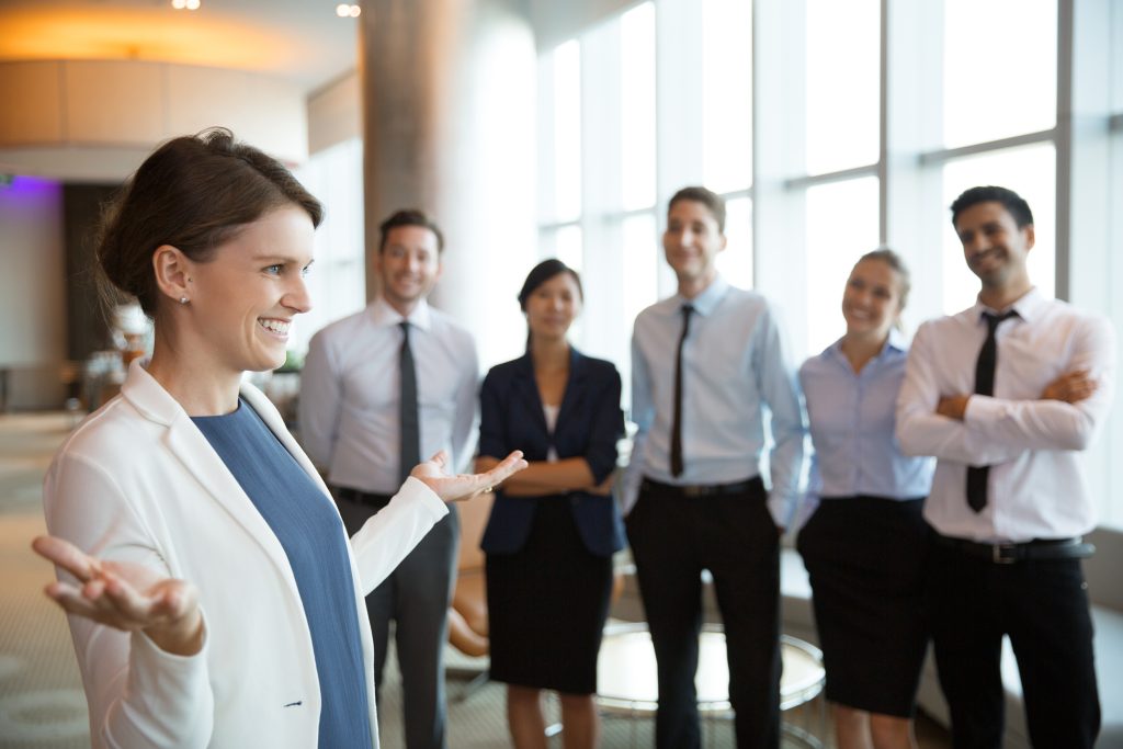 Office team listening as a colleague speaks during a group discussion.