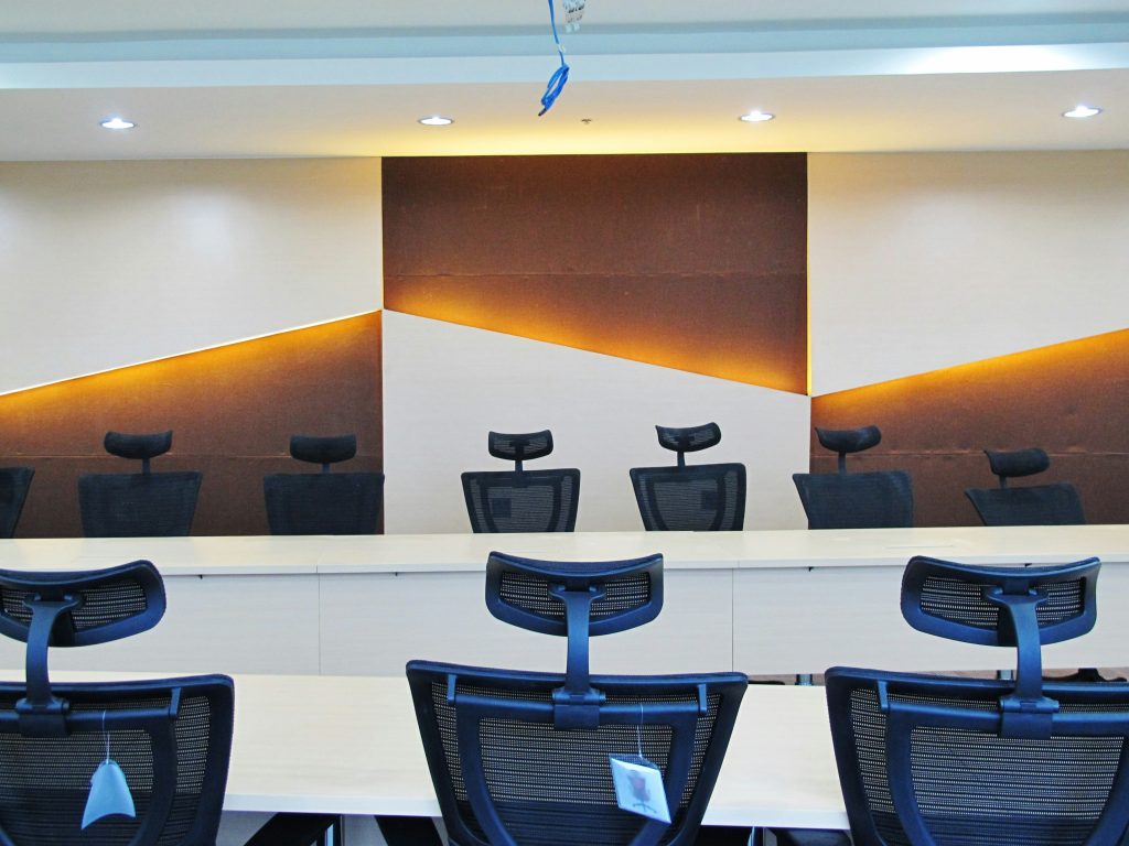 Empty training or conference room with chairs and a presentation area.