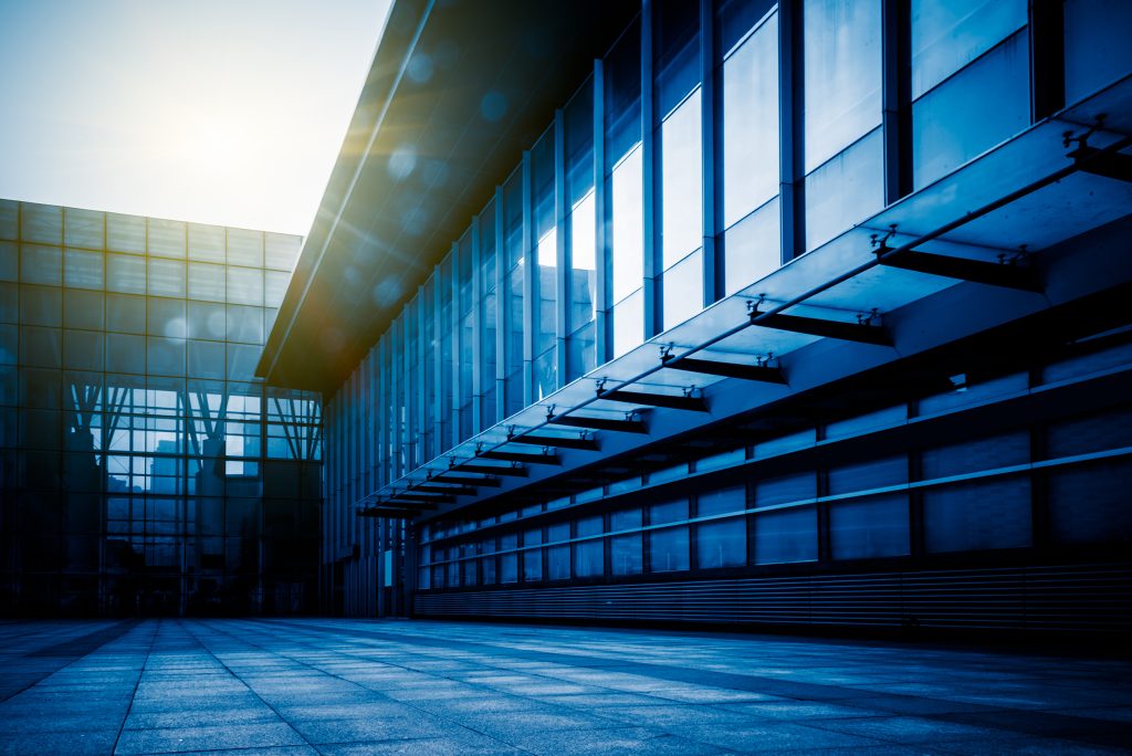 Exterior walkway of a contemporary office building with repeating columns.